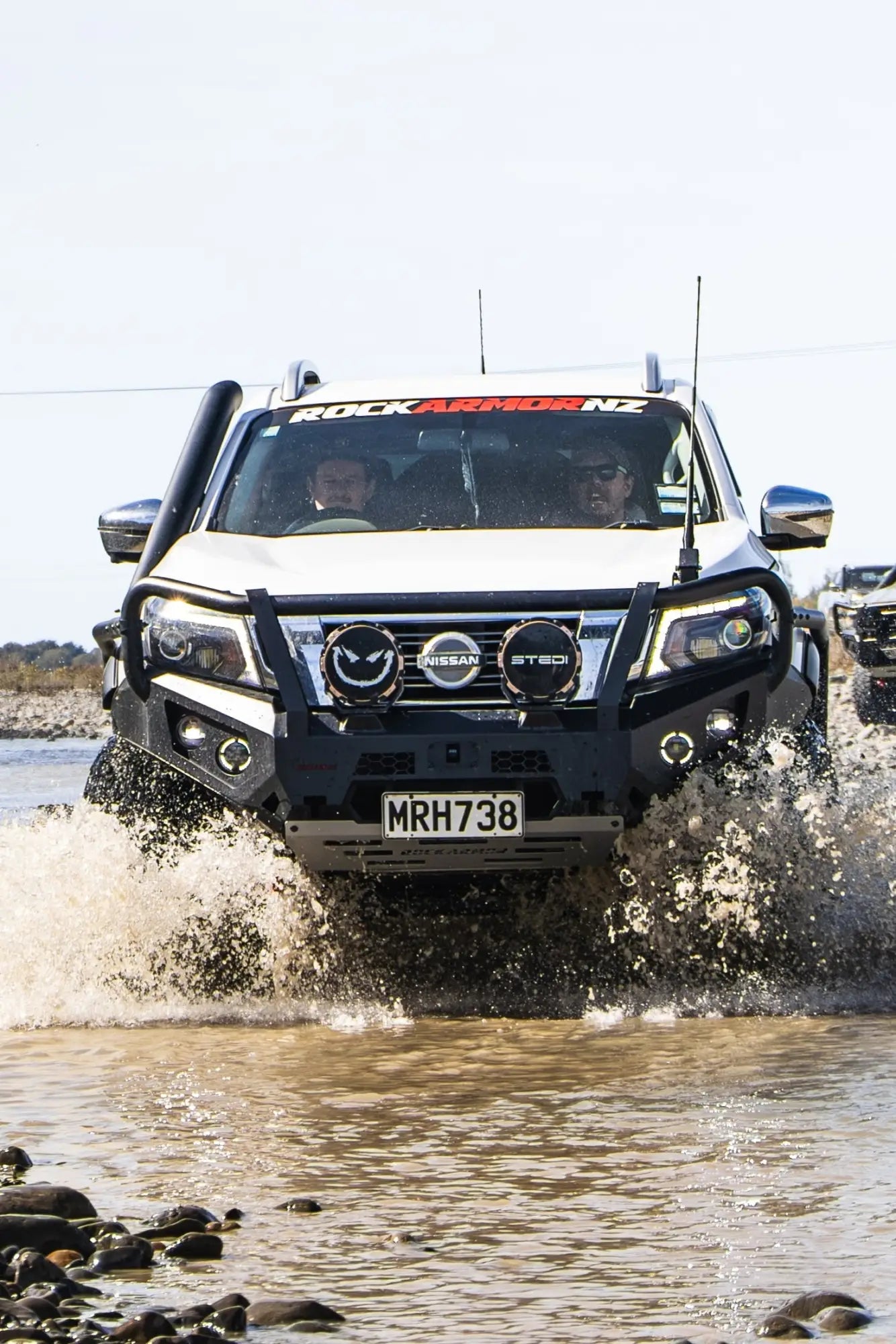 White Nissan Navara driving through water in the Bull Bar collection
