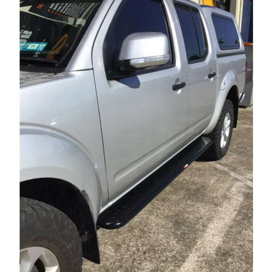 Silver pickup truck featuring rockarmor rockslider brushbar with black running boards for nissan navara d40 2005-2015