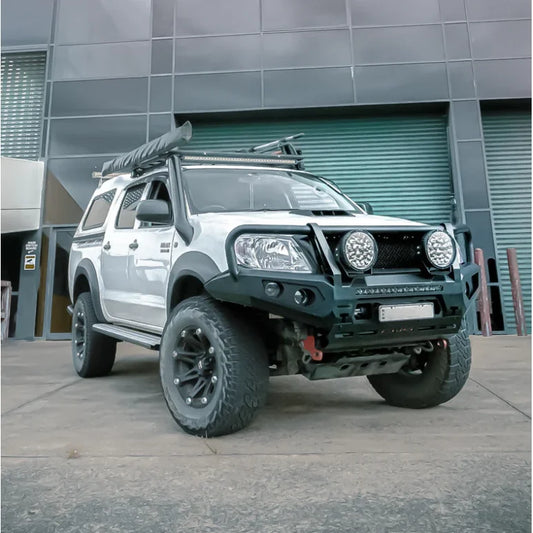 White off-road Toyota Hilux N70 featuring rockarmor gt steel hoop bullbar combo for enhanced front-end protection