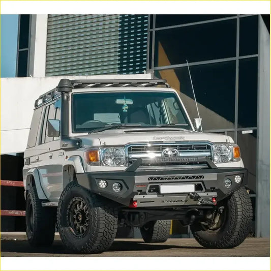 Silver toyota land cruiser 70 with black off-road tires and gt hoopless bullbar from rockarmor rock pack