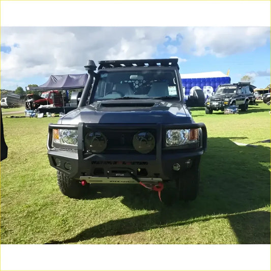 Black armored off-road toyota landcruiser 76 78 79 with rugged gt hoop bullbar roof rack and rock sliders
