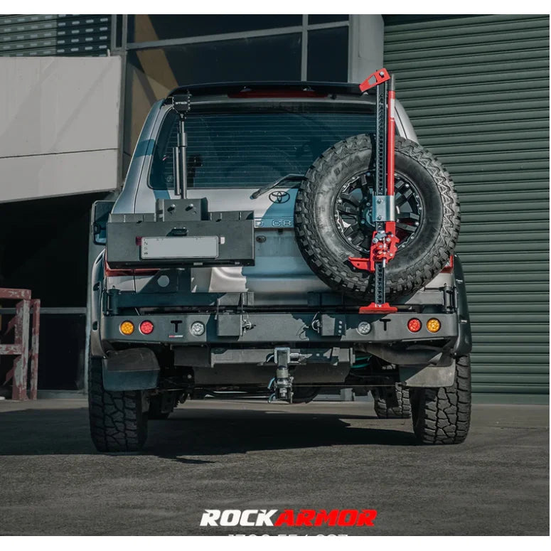 Silver truck with spare wheel and jack, featuring Rockarmor steel wheel carrier fitting video