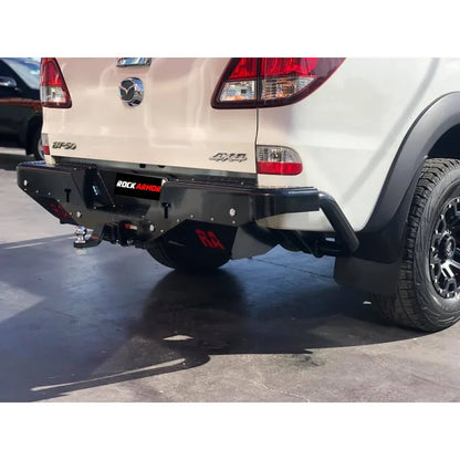 White mazda bt-50 pickup truck rear view featuring rockamor elite steel rear step aftermarket bumper 2011-2020