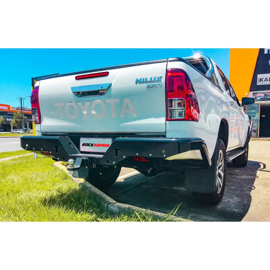 White toyota hilux n80 rear side featuring rockamor elite steel rear step and towbar made of durable steel