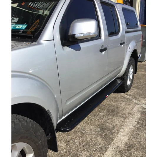 Silver Nissan Navara pickup with black brush bars and premium steel Rockarmor Brushbar