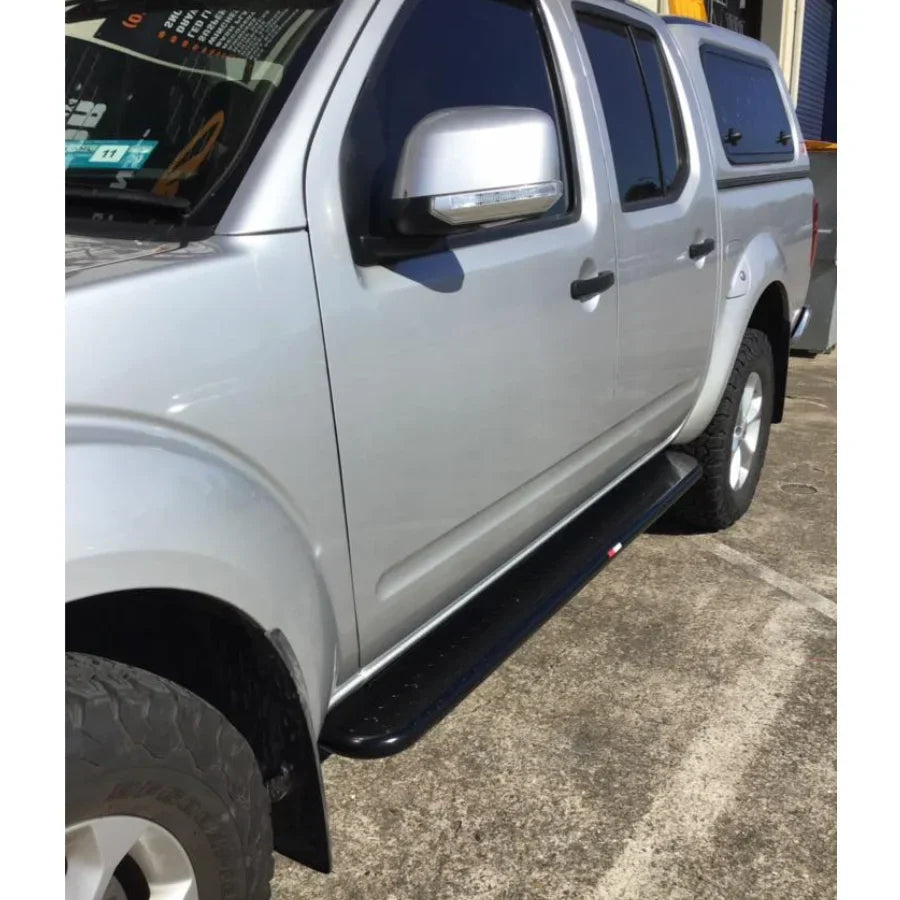 Silver pickup truck featuring rockarmor rockslider brushbar with black running boards for nissan navara d40 2005-2015