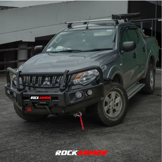Gray mitsubishi triton mq pickup truck fitted with rockarmor elite steel bullbar with fog lights and airbag compatible design