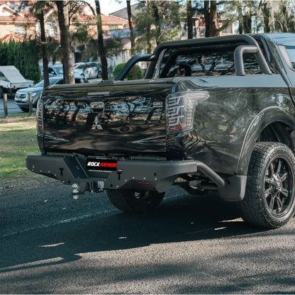 Black pickup truck rear showing rockarmor elite steel rear step tow bar in steel for mitsubishi triton mq 2015 2018