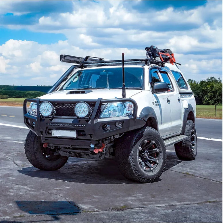 White off-road pickup truck with hoop steel bullbar for maximum frontal protection