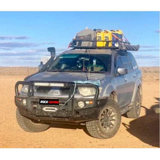 Gray mitsubishi triton with rockarmor premium steel bullbar featuring bumper cut and led fog lights on roof rack vehicle