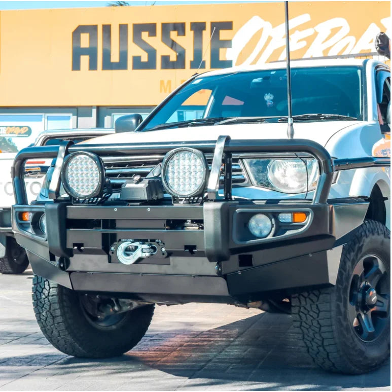 White mitsubishi triton mn/ml 2006-2015 with rockarmor premium steel bullbar featuring led fog lights and suspension upgrade