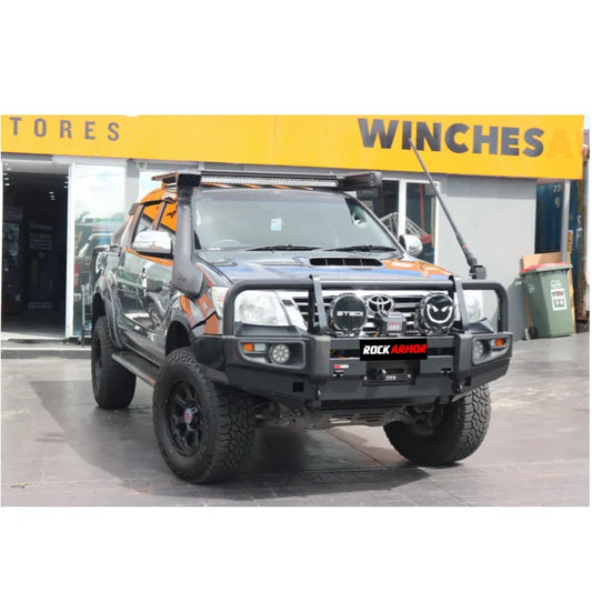 Modified gray toyota hilux fitted with rockarmor premium steel winch compatible bull bar with fog lights cutouts