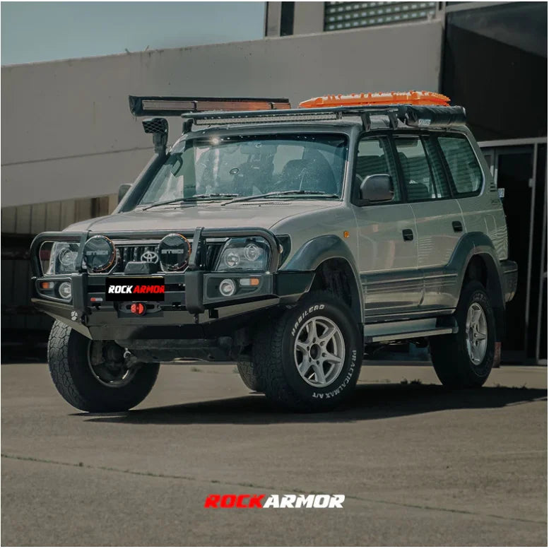 Silver toyota prado 1996-2002 with rockarmor premium steel bullbar featuring led fog lights replacement bar
