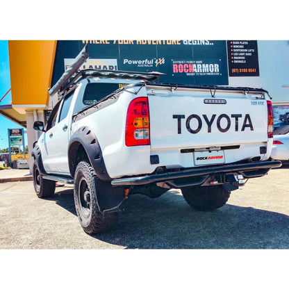 White Toyota Hilux rear view equipped with rockarmor premium steel rear step and 2500kg towing tow bar
