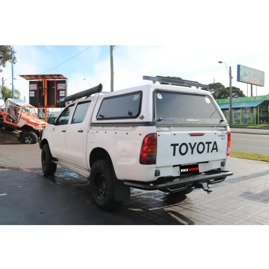 Rear view of white Toyota Hilux fitted with rockarmor premium steel rear step tow bar for 2500kg towing capacity