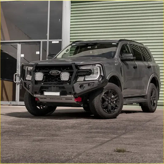 Dark gray ford ranger with black off-road bumper and wheels featuring rockarmor rock pack gt hoop bullbar and rock sliders