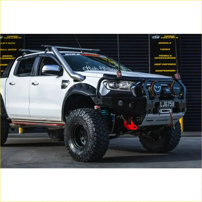 Black and silver ford ranger wildtrak off-road truck with gt hoop bullbar rugged tires and rock sliders