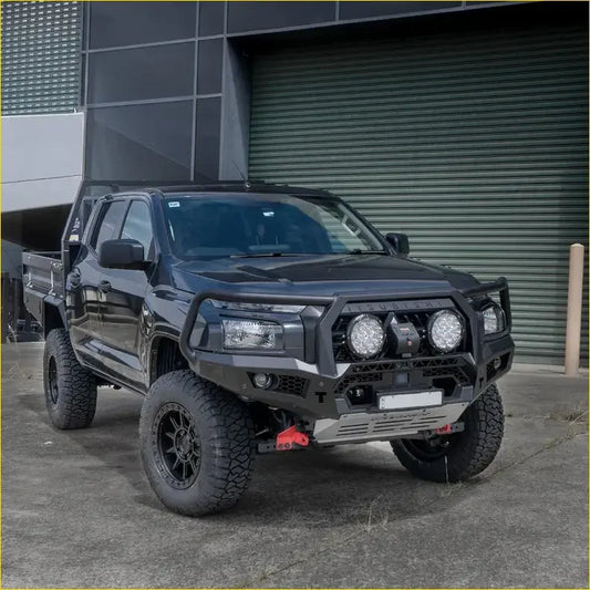 Black lifted mitsubishi mv triton 2024 with rockarmor gt hoop bullbar and rock sliders featuring off-road tires and aux lights