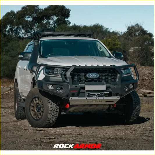 Silver ford everest pickup truck with black rockarmor front bumper and roof rack in rockarmor rock pack setup