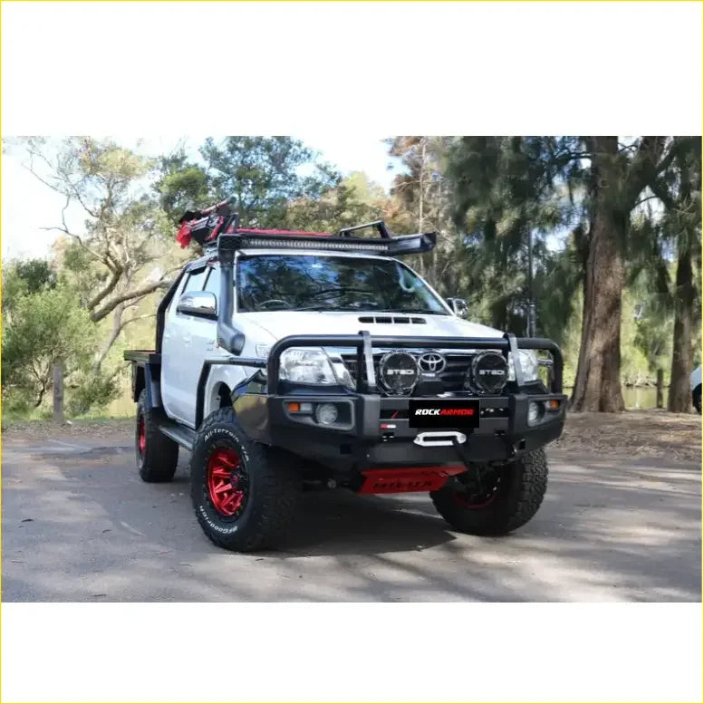 White toyota hilux n70 2005 2011 with black and red rockarmor rock pack premium bullbar and roof rack