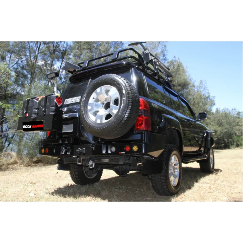 Black nissan patrol y61 with rockarmor steel dual wheel carrier mounted on rear and roof rack for off-road use