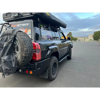 Black nissan patrol y61 featuring rockarmor steel dual wheel carrier with roof tent for off-road use 2004 to 2016 models