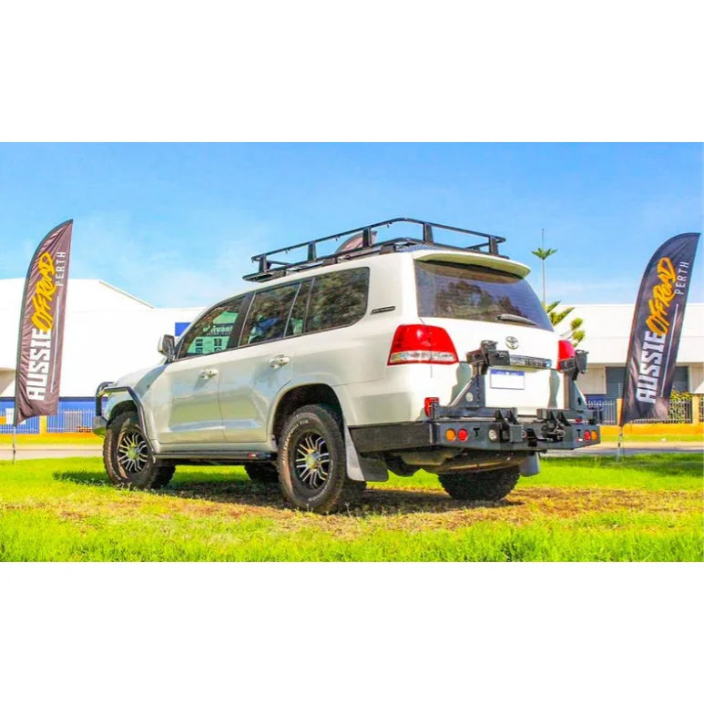 White off-road toyota landcruiser fj200 with rockarmor steel dual wheel carrier and roof rack at the rear side