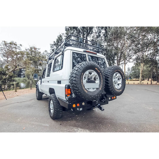 White off-road toyota landcruiser fj75 with rockarmor steel dual wheel carrier rear mounted and dual spare tires