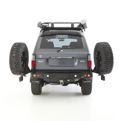 Gray rockarmor steel dual wheel carrier mounted on toyota landcruiser fj80 with dual spare tires rear view