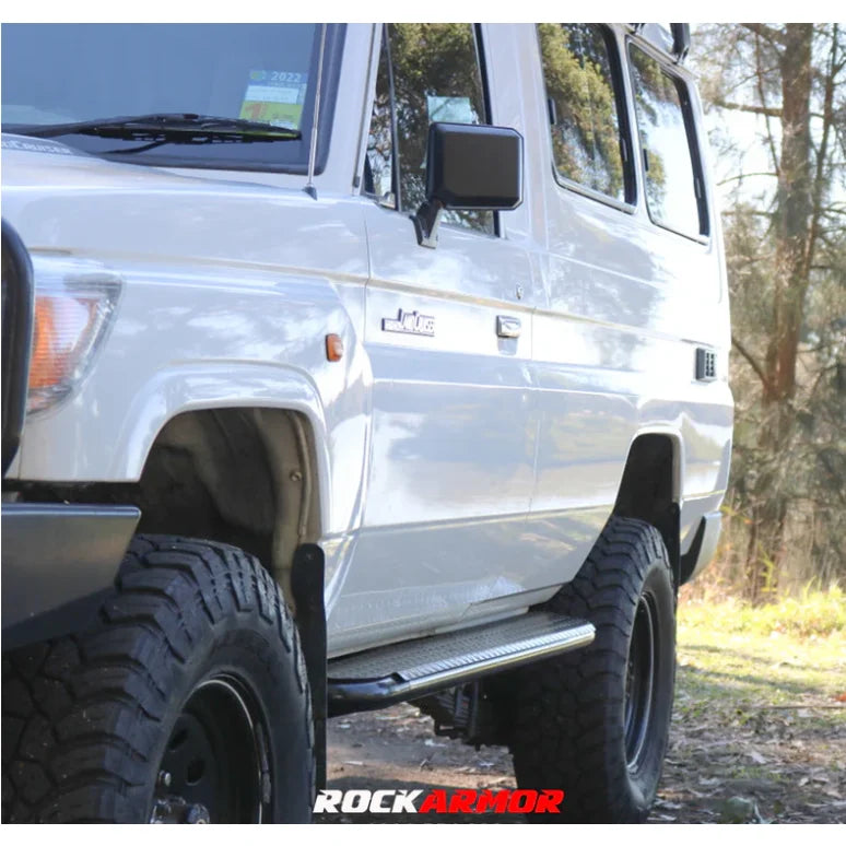 White off-road vehicle featuring rockarmor steel rockslider side steps in steel checker plate for series v8 troop use