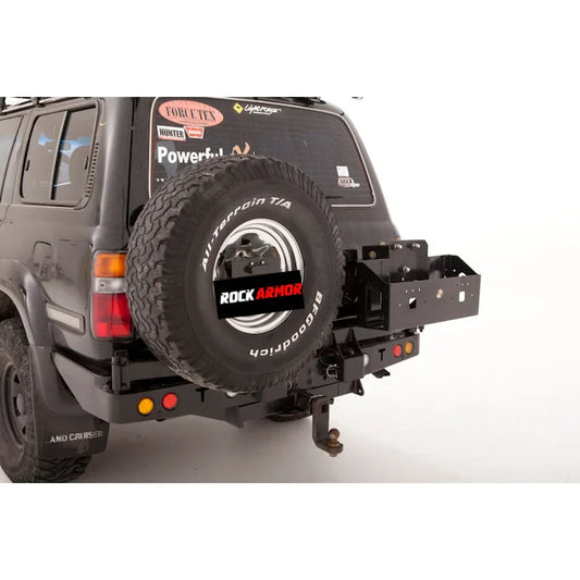 Black suv rear side featuring rockarmor dual jerry swing arm wheel carrier with lock for secure transport